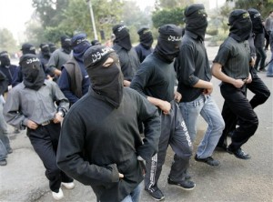 Masked Egyptian Muslim Brotherhood students parade inside their al-Azhar university campus in Cairo, Egypt. Photo: AP