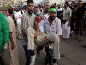 Wounded Egyptian being carried off after millions demonstrate against military rule. Photo: Screenshot.