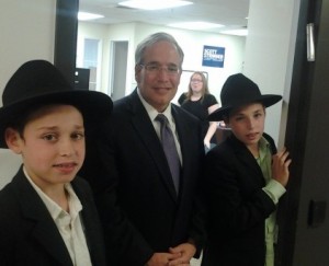New York Manhattan Borough President, and candidate for City Comptroller, affixes a mezuzzah to his campaign headquarters, with help from Mendy and Yossi Rotenstreich, of Chabad of Grammercy Park. Photo: Stringer for Comptroller.