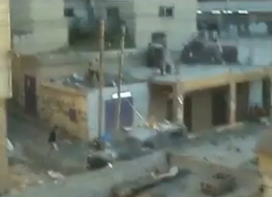 An Israeli security forces truck is pelted with stones, bricks, and wooden materials from rooftops by Arab youth in Qalandiya, in amateur eyewitness footage. Photo: Screenshot.