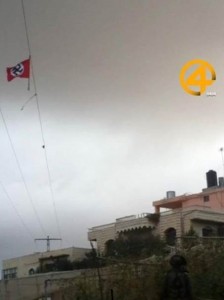 Nazi flag flying above Arab town, near Hebron. Photo: Screenshot / Ziv Edelstein / News 0404.