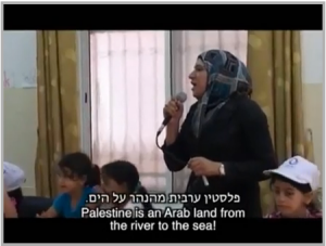In a classroom in Balata, near Nablus, a teacher indoctrinates students on "martyrdom" and has them chanting, "Palestine is an Arab land from the River to the Sea." Photo: Screenshot.