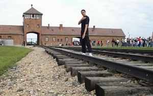 A Quenelle being photographed at Auschwitz. Photo: Screenshot.