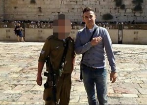 A Quenelle being photographed, unbeknownst to IDF soldier in Jerusalem. Photo: Screenshot.