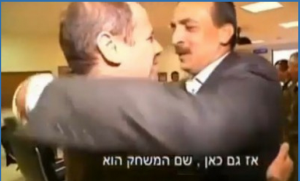 A controversial screenshot of a Gazan businessman hugging an Israeli general at a luncheon. Photo: Screenshot / Elder of Ziyon.
