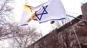 An Israeli flag is burned on a Purim demonstration by Satmar Hasidim, in Williamsburg, Brooklyn. Photo: Screenshot / Satmar Hasidim set fire to an Israeli flag in Williamsburg, Brooklyn on Purim. Photo: Screenshot / Jacob Kornbluh.