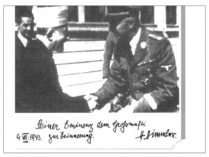 Screenshot showing a photo of Haj Amin al-Husseini meeting SS leader Heinrich Himmler,  with the dedication: To His Eminence the Grand Mufti as a memory; 4 VII: 1943; H.Himmler.