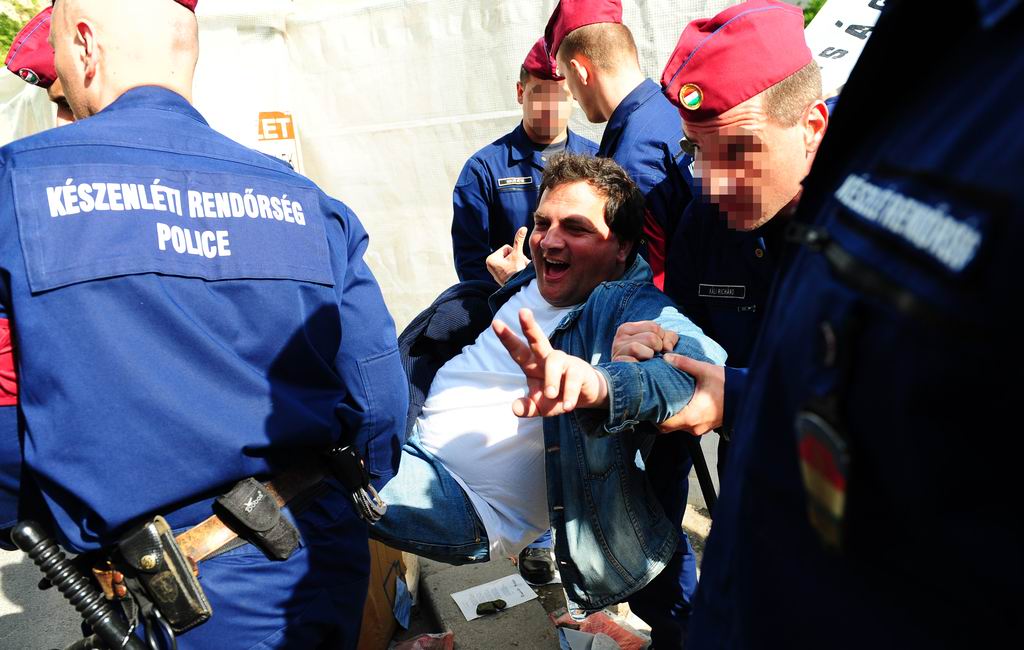 Photographs of sit-down protesters being removed by police in Budapest. Photo: Nepszabadsag Hungary.