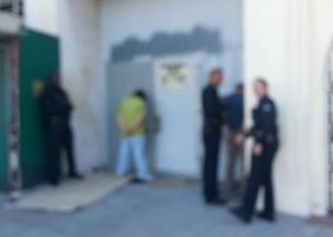 Blurry cellphone photo by Rabbi Michy Rav-Noy, as Los Angeles police detain and arrest anti-Semites who verbally assaulted the rabbi from moving bicycles. Photo: Facebook.