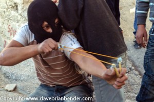 Palestinian youth aims slingshot at Israeli security forces in Jerusalem clash (archive)