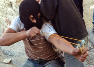Arab teen aims slingshot at Israeli security forces in Jerusalem clash (illustration, photo: Dave Bender)