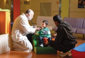 Dr David Mishali with young Syrian heart patient