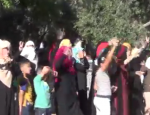 Arabs taunting 40 Jews on the Temple Mount with the three-fingered salute to mock the kidnapping of three Israeli teens abducted by Hamas. Photo: The Temple Institute / Screenshot.
