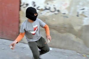 Palestinian youth throwing stones at Israeli forces (illustration)