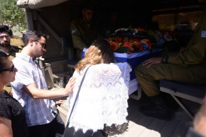 Paige Steinberg offers her last respects to her brother, Max, as his coffin is brought for burial. Photo: Facebook