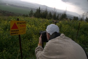 The author, photographing a minefield in the Israeli Golan Heights. Photo: Andy Alpern