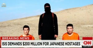 An ISIS executioner with two hostages. Photo: CNN/Screenshot. 