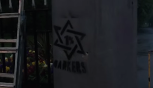 Members of the British fascist group National Action filmed their vandalism at a Jewish site and uploaded the video to YouTube. Photo: Screenshot.