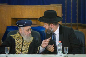 Sephardic Chief Rabbi of Israel Yitzchak Yosef (left) and Ashkenazi Chief Rabbi of Israel David Lau (right) speak at a rabbinic ordination ceremony of the Israeli Chief Rabbinate in Jerusalem on Sept. 4, 2014. Yosef recently issued a call to action for the Sephardic Jewish community to join Ashkenazim in embracing pre-marriage genetic testing. Photo: Yonatan Sindel/Flash90.