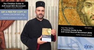 Father Gabriel Naddaf holds the Christian Empowerment Council new anti-BDS guide. Photo: Christian Empowerment Council.