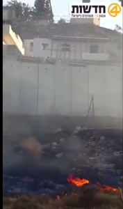 Palestinian arsonists set fire an open area with molotov cocktails, and then lay in wait to attack the firefighters with stones. PHOTO: 0404 News.