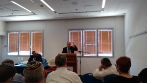 Rabbi Doron Perez (left, sitting at table) listens in as Rabbi Yechiel Wasserman, head of Diaspora religious affairs for the World Zionist Organization, speaks about Israel and Jewish continuity during the English-language track at the recent Tzohar conference in Jerusalem. Photo: Gil Segev.