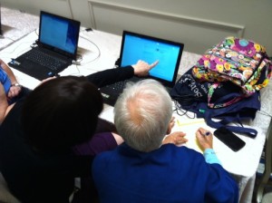 Attendees of the recent International Association of Jewish Genealogical Societies conference in Jerusalem perform research on a computer programmed to deliver genealogical services. Photo: Deborah Fineblum Schabb.