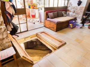 The living room of a Jerusalem home where a 2,000-year-old Jewish ritual bath was discovered under the floor. Photo: Israel Antiquities Authority.