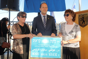 The nieces of Moshe Krausz, who saved 40,000 Jews during the Holocaust, next to the new street sign in honor of their uncle. Photo: Hillel Maeir, Tazpit Press Service.