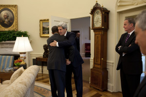 President Barack Obama and Secretary of State John Kerry embracing in the Oval Office. Photo: Wikimedia Commons.