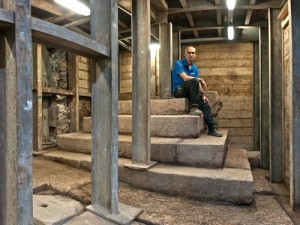 Dr. Joe Uziel, co-director of the excavation, with the unique structure. Photo: Shai Halevy via the Israel Antiquities Authority.  