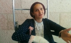 Odele Bennett, as she exits Hadassah Medical Center. Bennett was seriously wounded in a terrorist attack in the Old City of Jerusalem on Oct. 3, and her husband was killed. Photo: Screenshot.