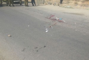 Blood is seen on the road where an Israeli man was run over by a truck while trying to avoid a rock attack Tuesday. Photo: Har Hebron security.