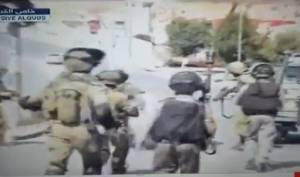 Israeli soldiers subdue a Palestinian terrorist disguised as a news photographer on Friday afternoon. Photo: nrg/Al-Quds TV/Screenshot.