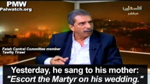 On Palestinian Authority television, Palestinian Fatah official Tawfiq Tirawi praises his 2-year-old son's desire to shoot Israelis. Credit: Palestinian Media Watch.