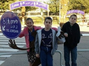 Three of the Israeli family's five children at the Jordanian border. The two brothers were not allowed in with their kippot. Photo: Facebook.
