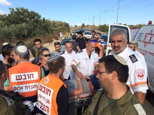 Israeli Magen David Adom (MDA) paramedics provide medical treatment to four adults and two children after stones were thrown at their car on Oct. 9. Photo: MDA.