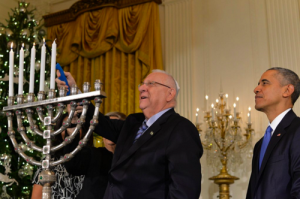 U.S. President Barack Obama looks on as Israeli President Reuven Rivlin lights the Hanukkah menorah at the White House on Wednesday. Photo: Reuven Rivlin via Twitter. 