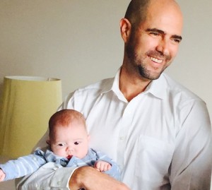 Member of Knesset Amir Ohana (Likud) holds David, one of his twin babies. Photo: Maayan Jaffe.