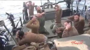 A screenshot of a video released by Iran showing several Americans kneeling, with their hands clasped behind their heads. Photo: Screenshot.
