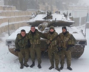 Israeli troops standing in front of a snow-covered military tank. Israel is in the midst of a winter storm. Photo: Twitter.