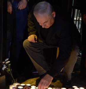Prime Minister lights a candle at the scene of the Tel Aviv attack. Photo: Facebook. 