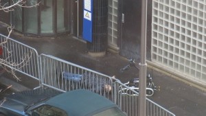 A robot appears to be inspecting the body. of the dead attacker. The assailant was shot dead outside a police station in northern Paris. Photo: Twitter.