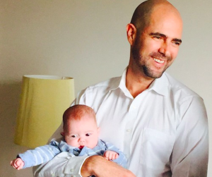 Member of Knesset Amir Ohana, the Likud party's first openly gay lawmaker, holds David, one of his twin babies. The Israeli Knesset held its first LGBT Rights Day. Photo: Maayan Jaffe.