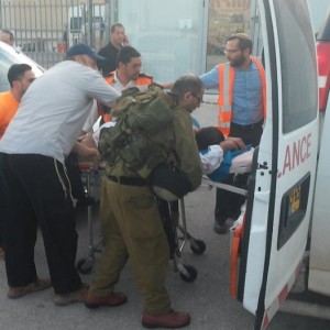 A victim being transported into an ambulance outside the West Bank supermarket where Palestinian teens went on a stabbing spree. Photo: Twitter.