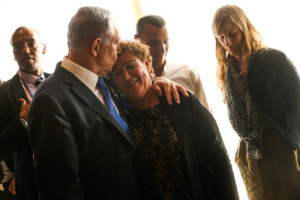 Israeli's Prime Minister Benjamin Netanyahu (L) kisses Miriam Peretz, mother of fallen Golani Brigade soldiers Uriel and Eliraz Peretz, during the opening session of the 20th Israeli parliament, held at the Knesset (Israeli parliament) on March 31, 2015. Photo by Nati Shohat/Flash90 .