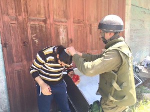 An IDF troop is seen helped an injured Palestinian who attackers thought was Jewish. Photo: Twitter.
