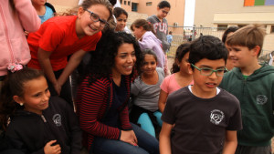  Wafa Hussein (in center), an Israeli-Arab Muslim from Deir Hanna who teaches Arabic and English to children in Safed, with her students in a scene from "My Home." Photo: My Home.