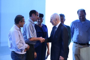 Former Israeli president Shimon Peres welcomes the parents of slain Jewish teenagers Eyal Yifrach, Gilad Shaar, and Naftali Frenkel to a ceremony at the Peres Center for Peace in Tel Aviv. Photo: Sean M. Murphy.