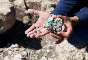 Archaeologist Abdel Al-Salam Sa'id holds a chunk of glass that proves Israel was a leader in Roman-era glass making. Photo: Assaf Peretz/Israel Antiquities Authority.